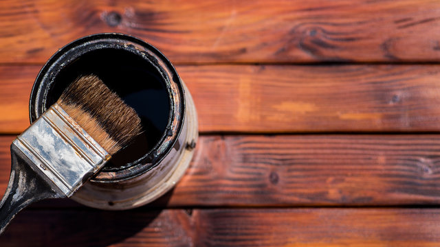 Old Used Paint Brush Next To A Paint Can, View From Above