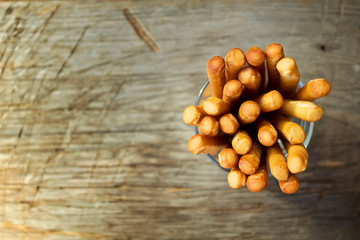 Breadsticks grissini on wooden background