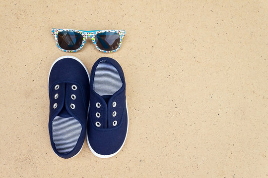 Blue sneakers and sunglasses. Summer holidays
