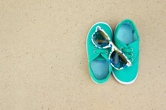Green sneakers and sunglasses