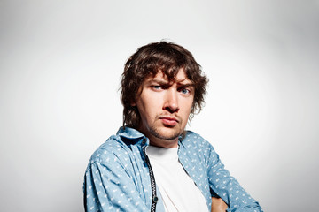 Closeup portrait distrust young man, guy, mad worker at isolated