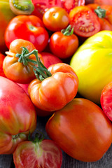 assorted tomatoes on wooden surface
