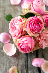 Fototapeta premium pink roses on wooden surface