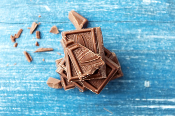 Chocolate bars on old wooden table top view