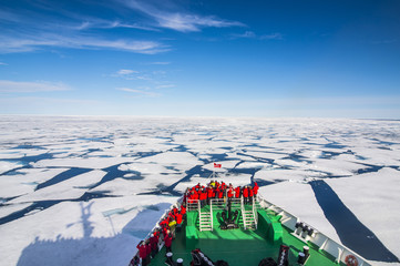 Expedition boat navigating through the pack ice in the Arctic shelf, Svalbard, Arctic