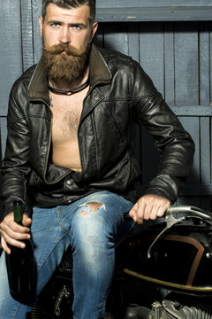 Handsome biker with bottle