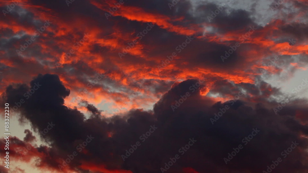 Sticker Dramatic black and red sunset clouds.
