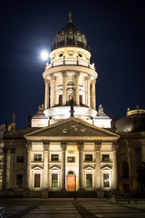statue reading at night, gendarmenmarkt, berlin germany