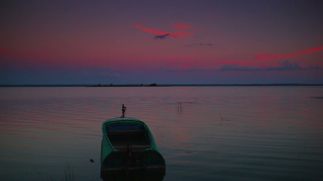 Lake with boat panorama at twilight.
