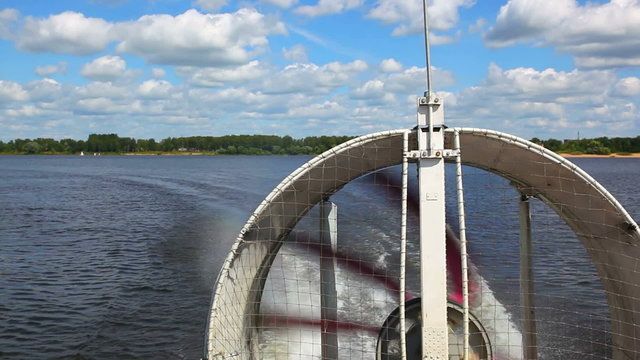 Hovercraft travel on river. View on big propeller at back.
