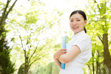 young asian nurse in the park 