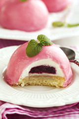 Mini cakes with black currant and creamy mousse.