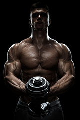 Fototapeta na wymiar Muscular man in dark background