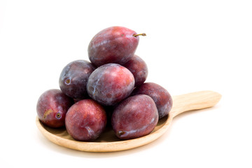 Fresh plums in wooden plate