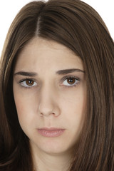 Naklejka premium A beautiful young woman's face showing despair.