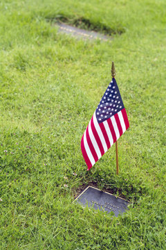 american flag on veteran graveside on memorial day