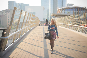 Young beautiful caucasian blonde girl in the city