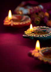 Fototapeta premium Colorful clay diya lamps lit during diwali celebration