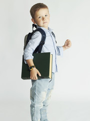 little boy going to school.child with backpack and book.education