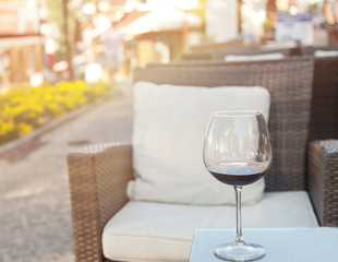 glass of red wine on a table at an outdoor cafe