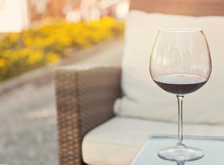 glass of red wine on a table at an outdoor cafe