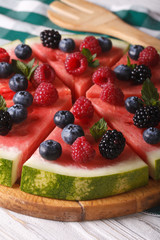 pizza watermelon with fresh berries and mint close-up. vertical