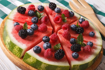 watermelon pizza with fresh berries and mint close-up. horizontal
