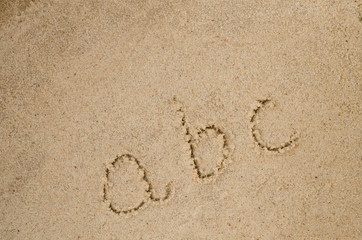 abc letters on sand