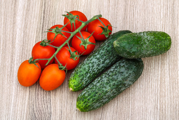 Cucumbers and tomatoes on the branch