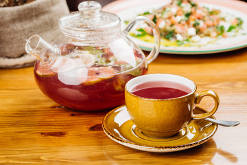 cup of tea and kettle  on wooden background