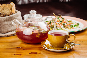 cup of tea and kettle  on wooden background