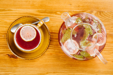 cup of tea and kettle  on wooden background