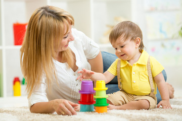 mom and child playing block toys at home