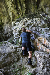 Naklejka na ściany i meble Man climbing on rocky mountain
