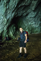 Man with photo camera in a cave