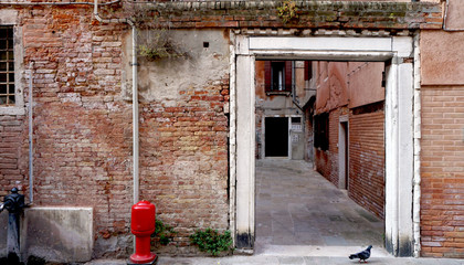 Alley with ancient brick wall building