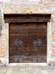 close up wooden door with brick wall