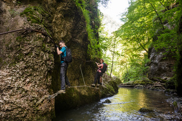 Hikers climbing above the river