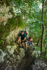 Backpackers on a safety cable on the wall