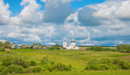 Rural landscape with wooden houses and white temple