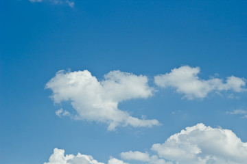 Blue sky background with a tiny clouds.
