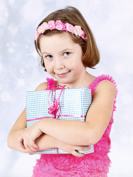 LIttle girl holding a present