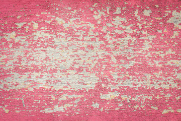 Flaking Red Paint on Faded Wood Background.
