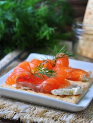 crackers with cheese curd, pickled salmon and dill