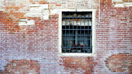 Fototapeta na wymiar Window and old brick wall building