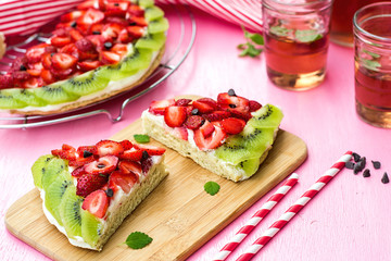 Sponge cake with strawberries and kiwi in shape of watermelon