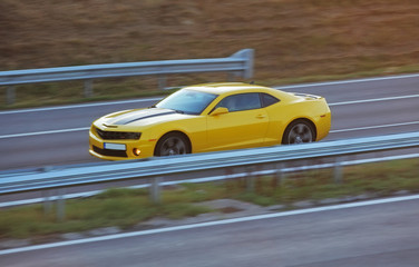 Obraz na płótnie Canvas Yellow car on road