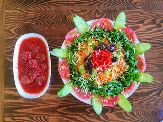 Top view of pickles with chili sauce and season salad