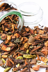 Tea with fruit and dry flower in glass jar on white background