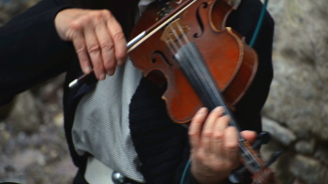 Woman playing violin on the street.